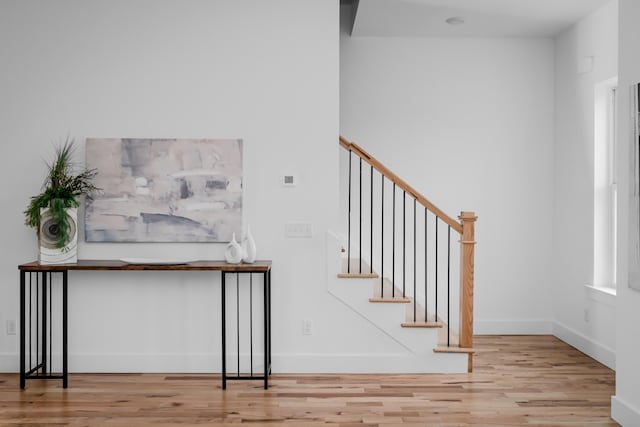 stairway with light wood-type flooring