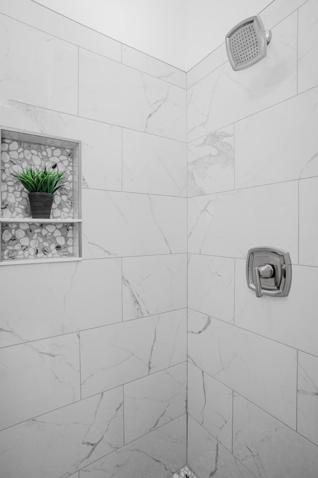 interior space featuring a tile shower