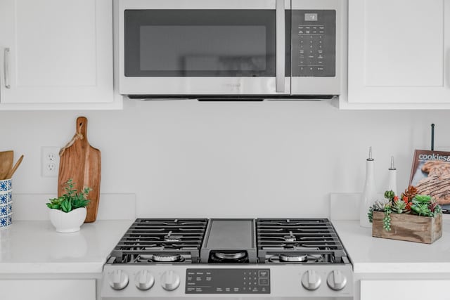 kitchen featuring white cabinets and appliances with stainless steel finishes