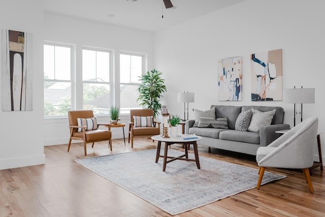 living room featuring ceiling fan and light wood-type flooring