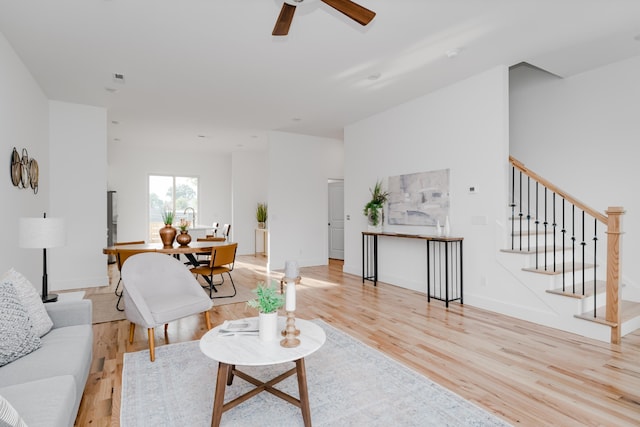 living room with ceiling fan and light hardwood / wood-style flooring