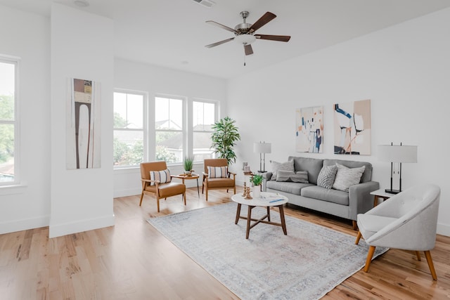 living room featuring ceiling fan and light wood-type flooring