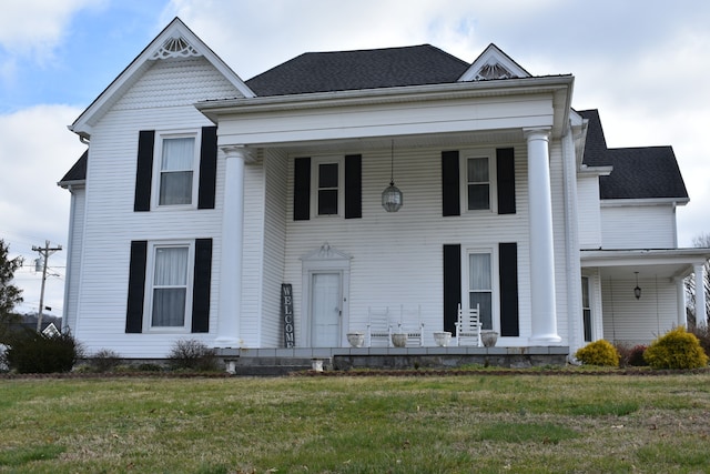 view of front of property featuring covered porch and a front lawn