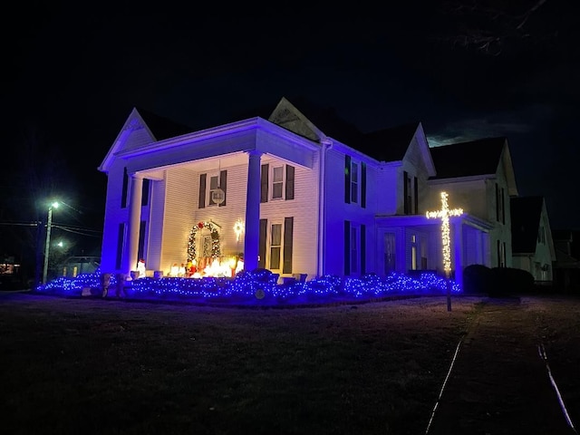 view of back house at twilight