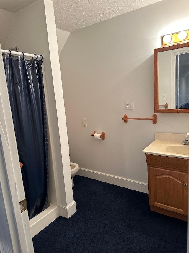 bathroom featuring vanity, a shower with curtain, a textured ceiling, and vaulted ceiling