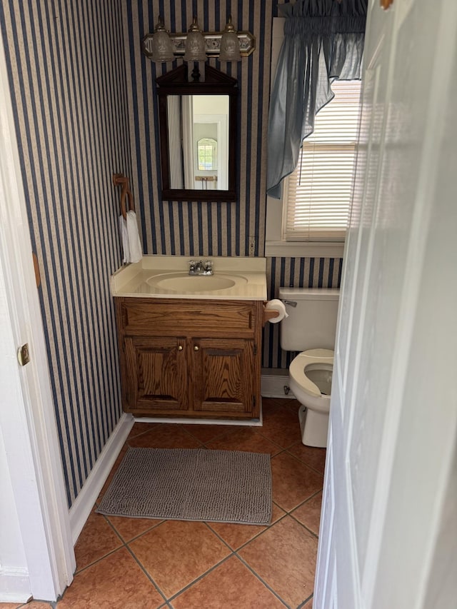 bathroom featuring tile patterned flooring, vanity, and toilet