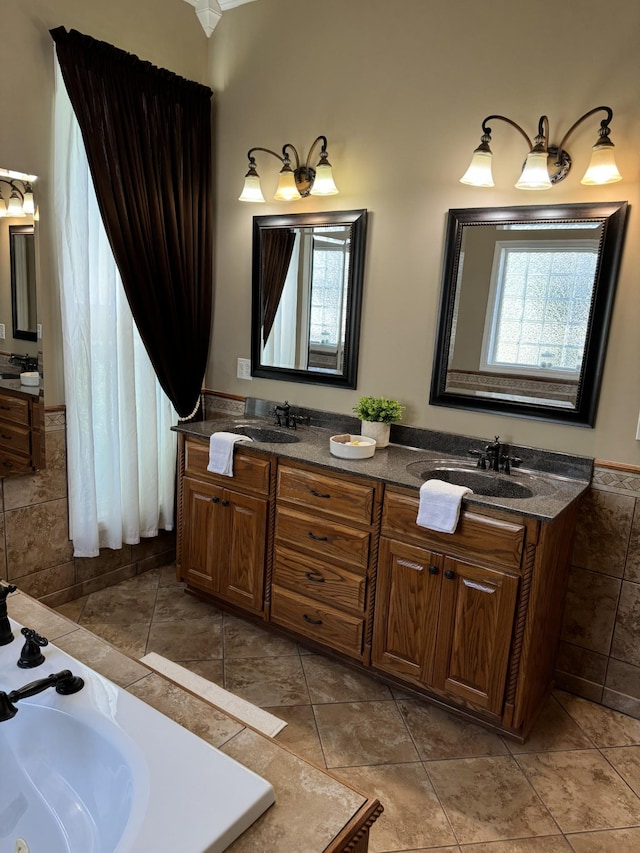 bathroom featuring tile patterned floors, a washtub, and vanity