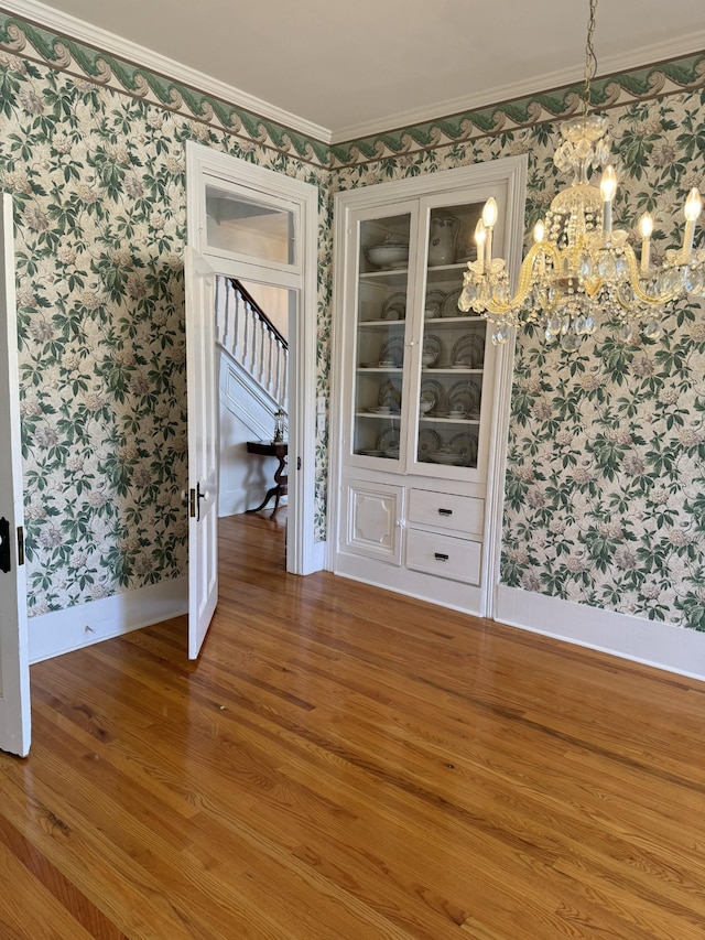 unfurnished room featuring crown molding and hardwood / wood-style flooring