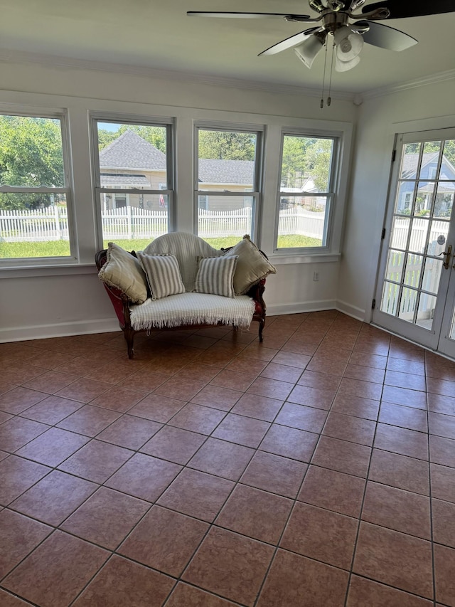 sunroom / solarium featuring ceiling fan