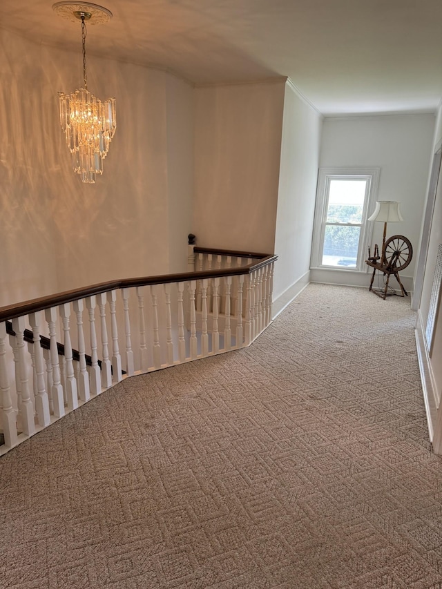 hall with a chandelier and carpet floors