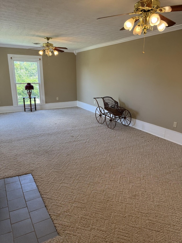 unfurnished room with ceiling fan, ornamental molding, and a textured ceiling