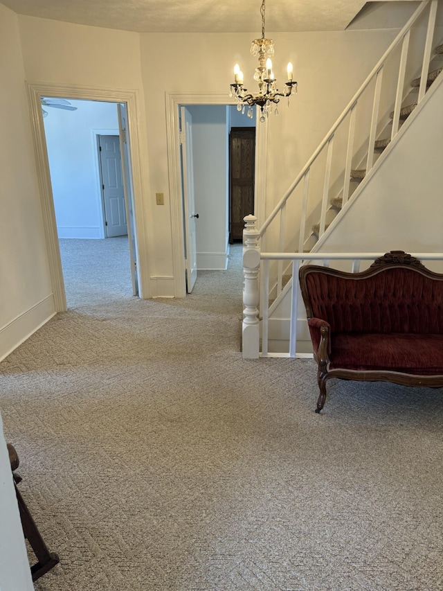 stairway featuring carpet and a chandelier