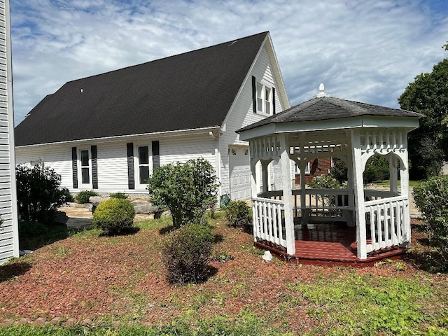 back of property with a gazebo