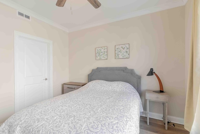 bedroom featuring crown molding, ceiling fan, and hardwood / wood-style flooring