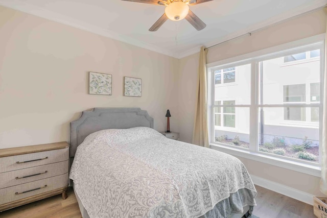 bedroom with ceiling fan and light hardwood / wood-style flooring