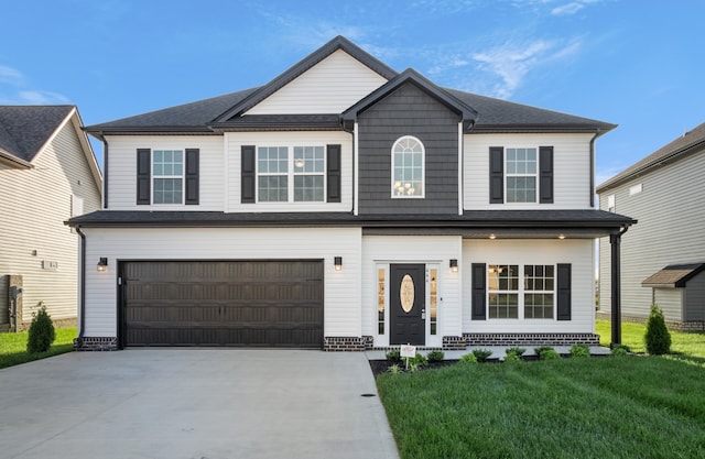 view of front of house with a garage and a front yard