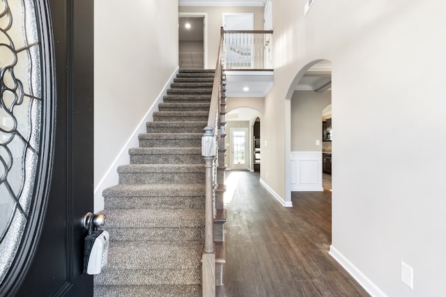 entrance foyer with dark wood-type flooring and ornamental molding