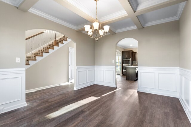 unfurnished dining area featuring beam ceiling, coffered ceiling, an inviting chandelier, dark hardwood / wood-style flooring, and crown molding