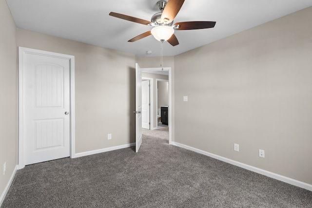 unfurnished bedroom featuring ceiling fan and dark carpet