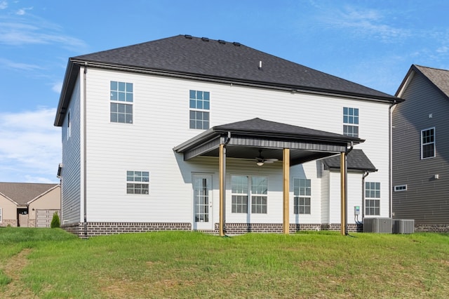 back of property with a lawn, ceiling fan, and cooling unit