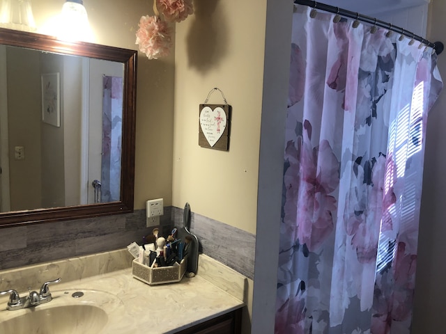 bathroom with vanity and curtained shower