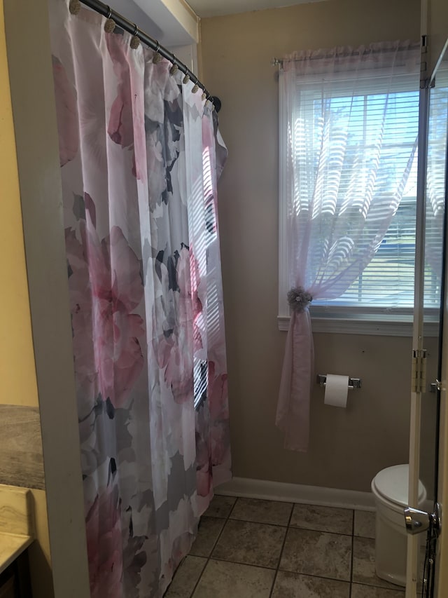 bathroom featuring vanity, tile patterned flooring, curtained shower, and toilet