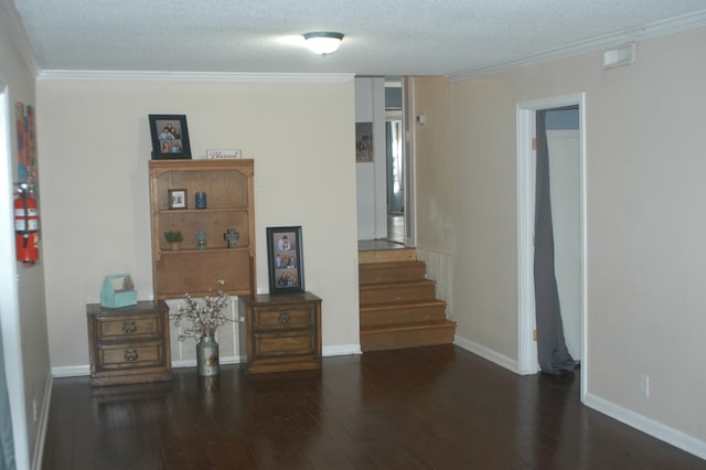 interior space with a textured ceiling, crown molding, and wood-type flooring