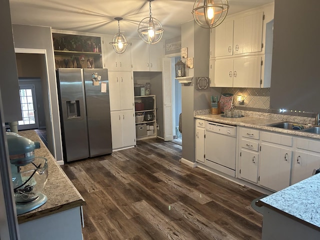 kitchen featuring decorative light fixtures, white cabinetry, white dishwasher, decorative backsplash, and stainless steel fridge