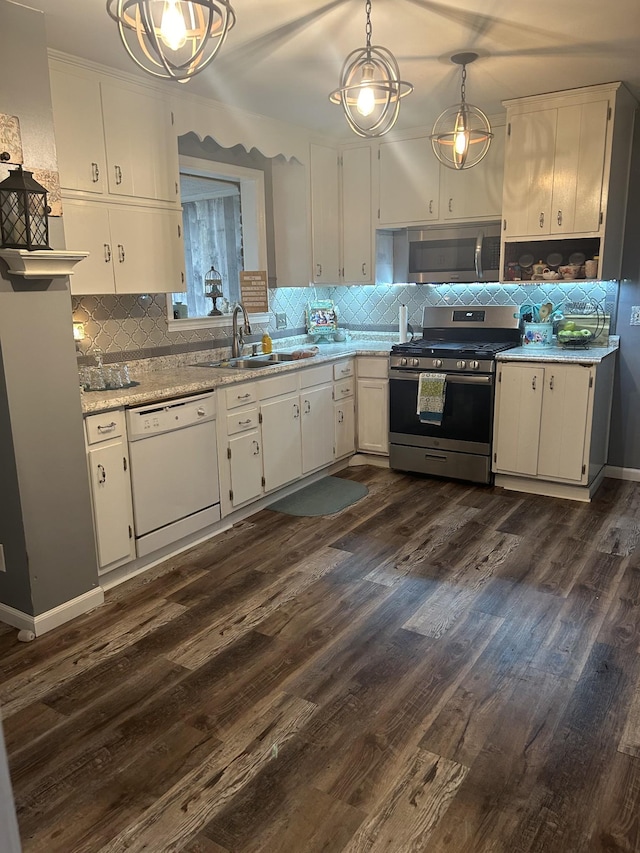 kitchen with hanging light fixtures, dark hardwood / wood-style flooring, white cabinets, appliances with stainless steel finishes, and sink