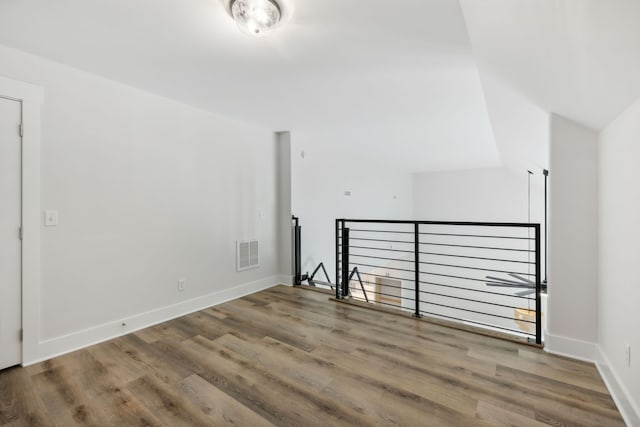 additional living space with hardwood / wood-style floors