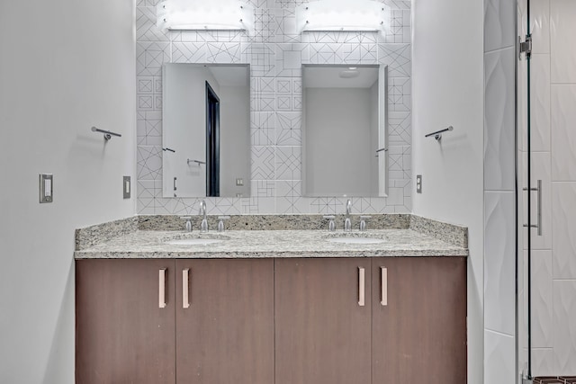 bathroom featuring tile walls and dual bowl vanity