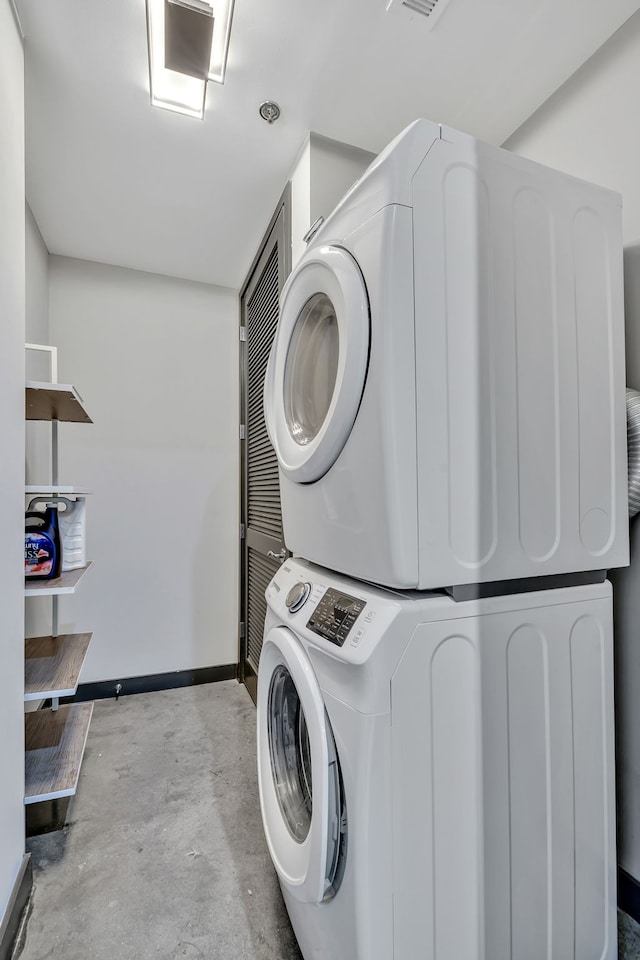 washroom featuring stacked washer / dryer