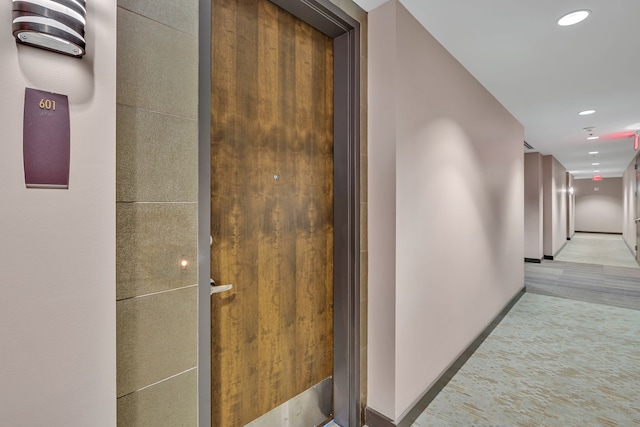 hallway featuring light carpet