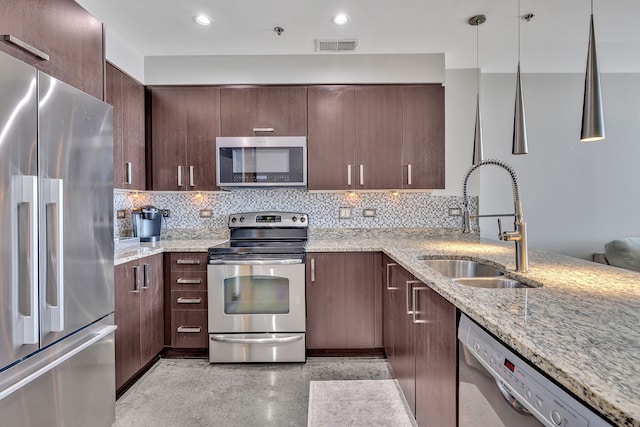 kitchen featuring light stone countertops, tasteful backsplash, stainless steel appliances, and sink