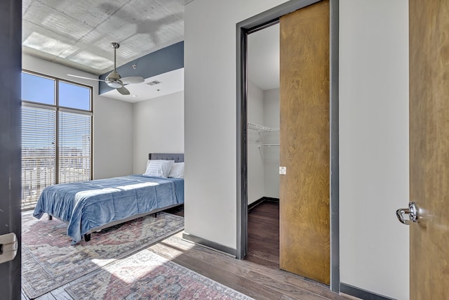 bedroom with dark hardwood / wood-style flooring, a closet, and ceiling fan