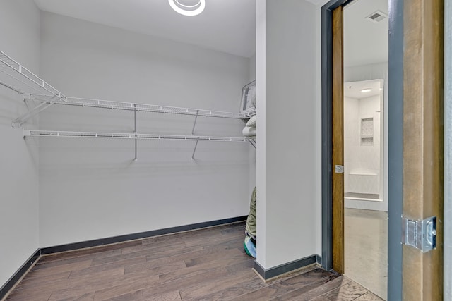 walk in closet featuring dark wood-type flooring