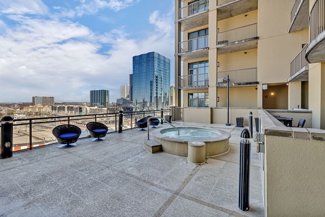 view of patio / terrace with a balcony and a community hot tub