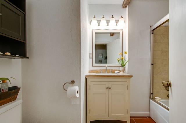 full bathroom with vanity with extensive cabinet space, tile floors, toilet, and combined bath / shower with glass door