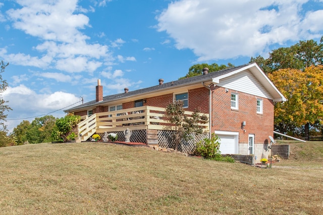 view of side of home with a wooden deck, a lawn, and a garage