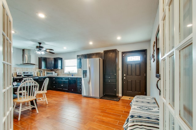 living room featuring ceiling fan, sink, and light wood-type flooring