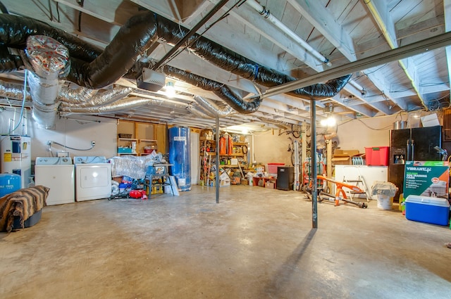 basement featuring electric water heater and washing machine and dryer