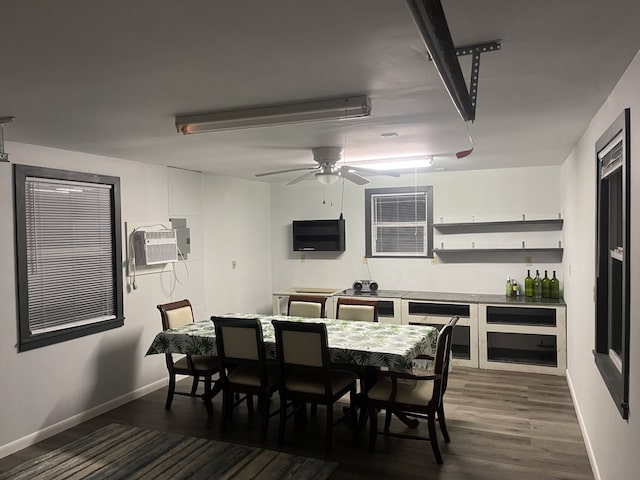 dining area with dark hardwood / wood-style floors, ceiling fan, and an AC wall unit