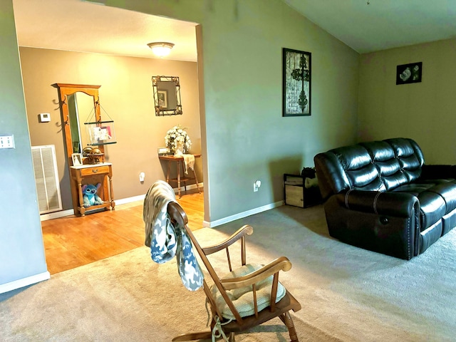 carpeted living room with vaulted ceiling