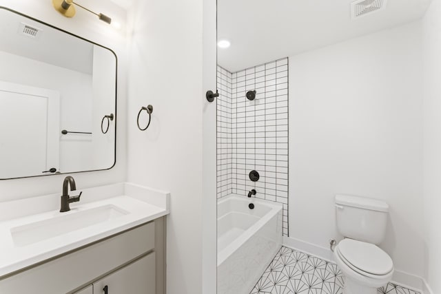 full bathroom with toilet, tile flooring, tiled shower / bath combo, and vanity