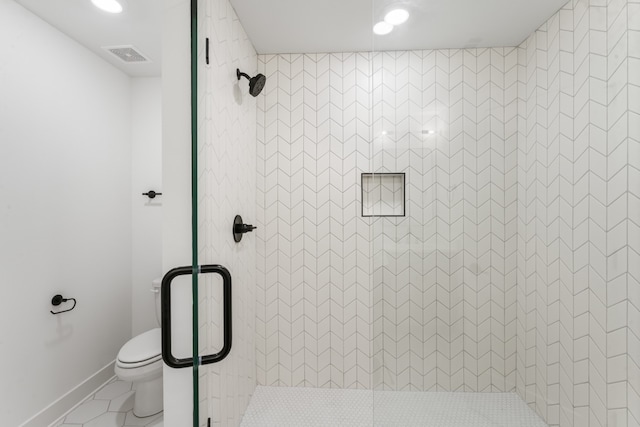 bathroom featuring walk in shower, tile flooring, and toilet