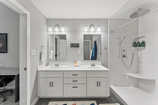 bathroom featuring dual vanity and walk in shower