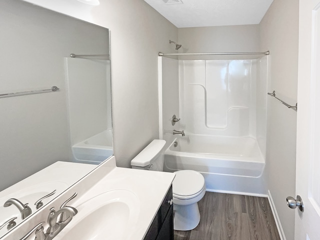 full bathroom featuring toilet, hardwood / wood-style flooring, vanity, and shower / bath combination