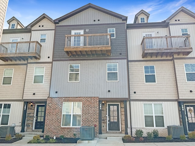 view of front of property featuring a balcony and central AC unit