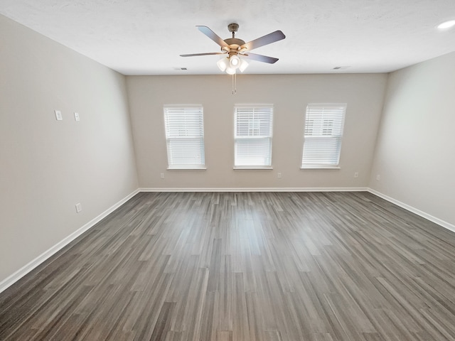 unfurnished room featuring ceiling fan and dark hardwood / wood-style flooring