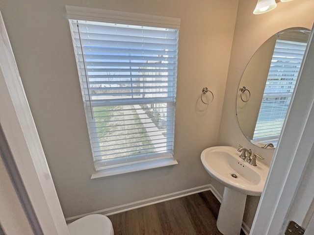 bathroom featuring sink, wood-type flooring, and toilet